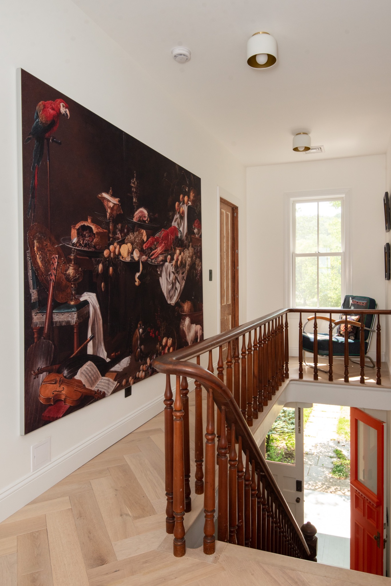 Large-scale classical still life artwork installation in residential stairwell